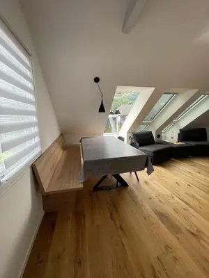 a living room with a bench in the middle of a room at Walter Apartments in Gozd Martuljek