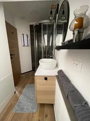 a small bathroom with a sink and a mirror at Walter Apartments in Gozd Martuljek
