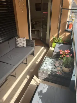 a patio with a couch and a coffee table at Apartment Anaa in Radovljica