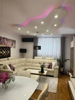 a living room with white furniture and a purple ceiling at Apartment Anaa in Radovljica