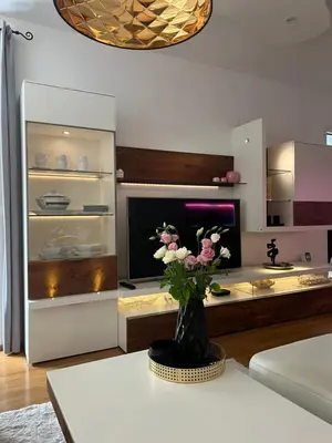 a living room with a vase of flowers on a table at Apartment Anaa in Radovljica