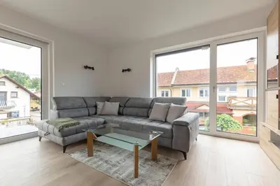 a living room with a couch and a table at Apartment Božica in Ljubljana