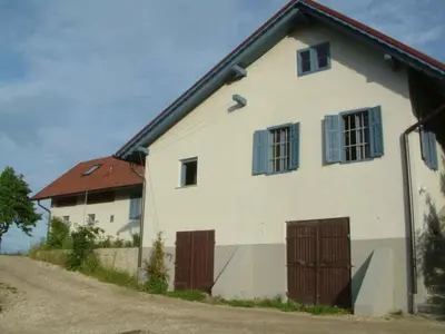 a white house with brown doors and a road at Paulusberg Comfortable holiday residence in Ivanjkovci