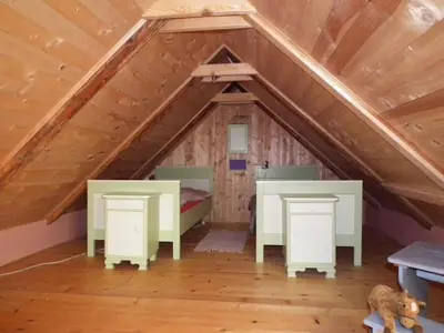 a room with a bed and desks in a attic at Paulusberg Comfortable holiday residence in Ivanjkovci