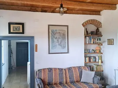 a living room with a couch and a book shelf at Paulusberg Comfortable holiday residence in Ivanjkovci