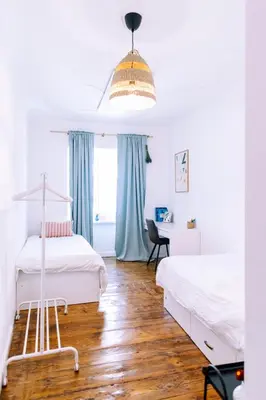 a bedroom with two beds and a desk at Cozy flat in Center in Maribor