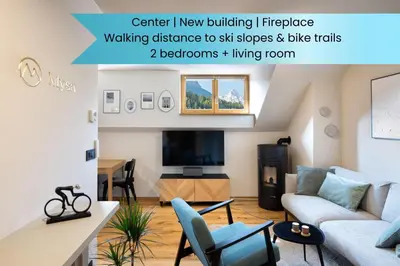 a living room with a couch and a tv at Apartment MYSA, Nordic House, Kranjska Gora - Center in Kranjska Gora