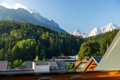 a view of a town with mountains in the background at Apartment MYSA, Nordic House, Kranjska Gora - Center in Kranjska Gora