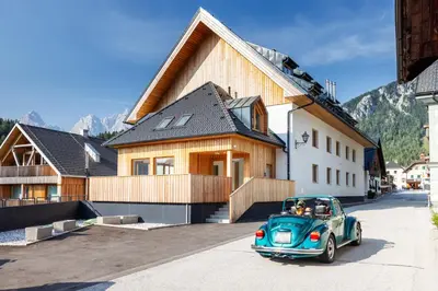 a small blue car parked in front of a house at Apartment MYSA, Nordic House, Kranjska Gora - Center in Kranjska Gora