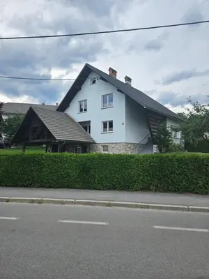 a white house on the side of a street at Apartments Zalar Bled in Bled