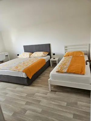 two beds sitting next to each other in a bedroom at Apartments Zalar Bled in Bled