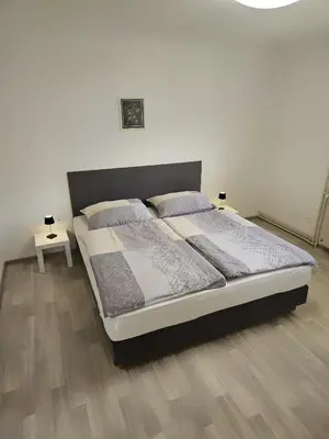 a bedroom with a bed with two lamps on it at Apartments Zalar Bled in Bled