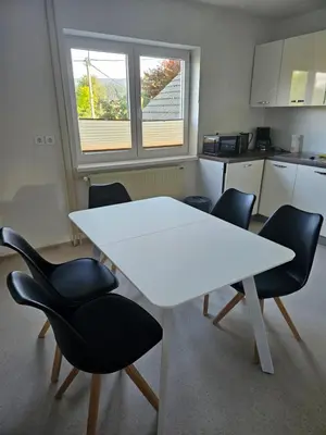 a white table and chairs in a kitchen at Apartments Zalar Bled in Bled