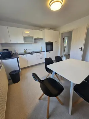 a kitchen and dining room with a table and chairs at Apartments Zalar Bled in Bled