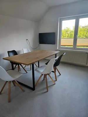 a conference room with a wooden table and chairs at Apartments Zalar Bled in Bled