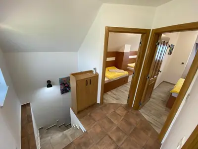 a small room with a door to a bedroom at Vineyard Cottage Joanna in Mirna Peč