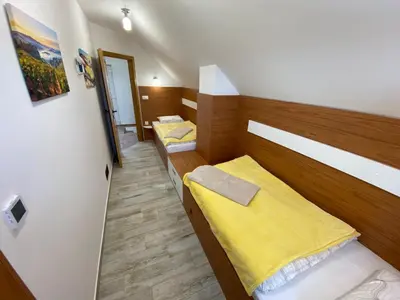a small room with two beds in it at Vineyard Cottage Joanna in Mirna Peč