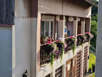 a building with flowers on the balconies at Apartment Relax in Raskrižje