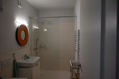 a bathroom with a shower and a sink and a shower at Apartment Relax in Raskrižje