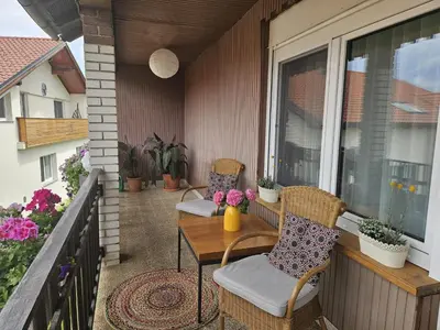 a patio with two chairs and a table on a balcony at Apartment Relax in Raskrižje