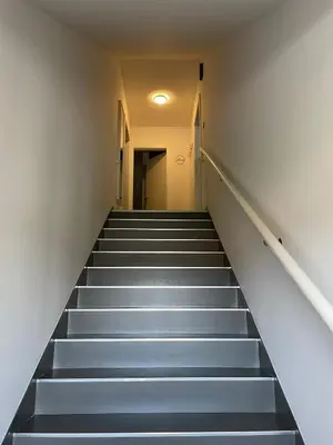a staircase in a building with grey steps at Apartma S in Sežana