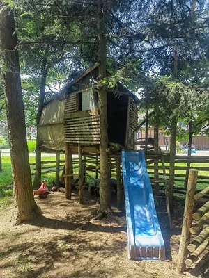 a tree house with a slide and a playground at WoW sleeping in Miklavž na Dravskem Polju