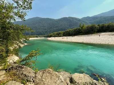 a view of a river with people on the beach at Apartma Savan in Tolmin