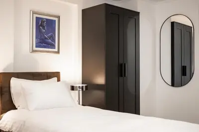 a bedroom with a bed and a mirror at Brodnik Apartment in Trbonje