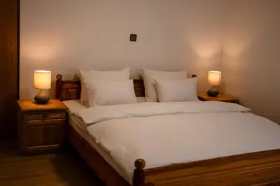 a bedroom with a bed with two lamps on tables at Brodnik Apartment in Trbonje