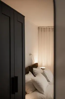 a mirror reflection of a bed with white pillows at Brodnik Apartment in Trbonje