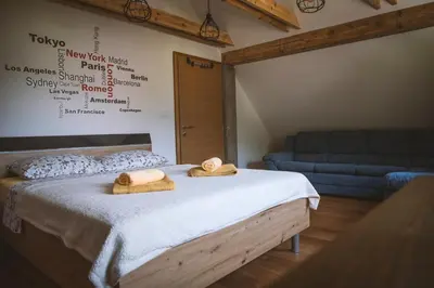 a bedroom with a bed with two towels on it at 4 Sheeps Apartments in Bovec