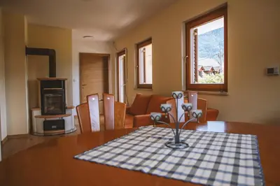 a living room with a table with a vase of flowers on it at 4 Sheeps Apartments in Bovec