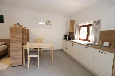 a kitchen with a table and a sink and a table at Studio Pr' Oreharjo in Zgornje Gorje