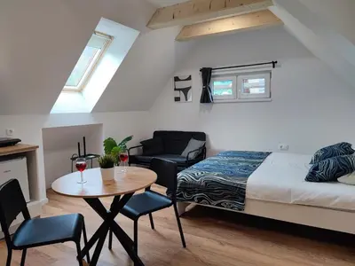 a bedroom with a bed and a table and chairs at Slovenian House Mira in Zgornje Gorje