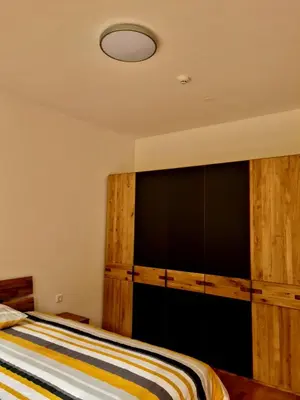 a bedroom with a bed with a wooden wall at Woodstone 6 in Pekre