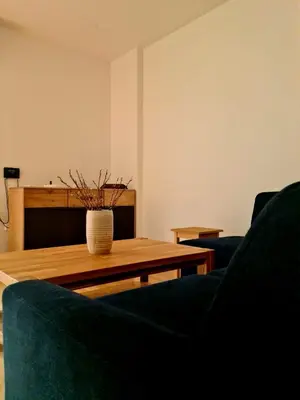 a living room with two blue chairs and a coffee table at Woodstone 6 in Pekre