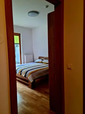 a bedroom with a bed and a door leading into a room at Woodstone 6 in Pekre