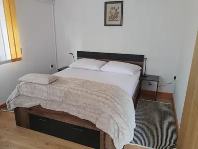 a bedroom with a bed with a blanket on it at apartma Grad in Motnik