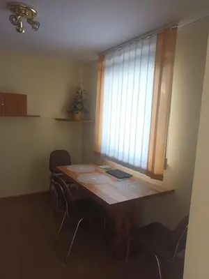 a room with a table with chairs and a window at apartma Grad in Motnik
