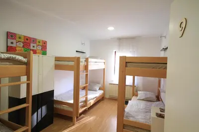a room with three bunk beds in it at Hostel Vrba in Ljubljana