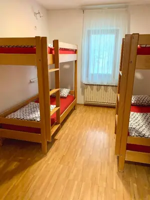 a room with three bunk beds and a window at Hostel Vrba in Ljubljana