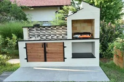 a house with two garage doors and a toy car at Mala Vila Kolpa in Griblje