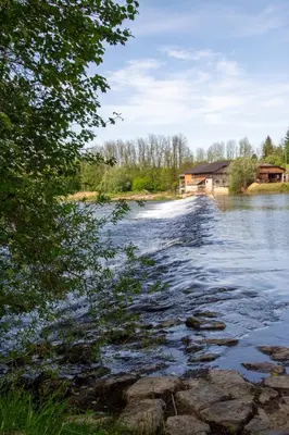a view of a river with a house in the background at Mala Vila Kolpa in Griblje
