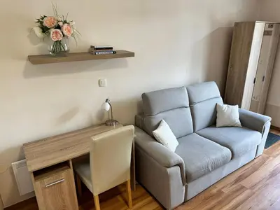 a living room with a couch and a table at Cozy Corner Ljubljana in Ljubljana
