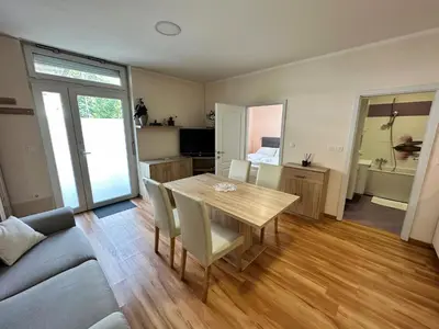 a living room with a wooden table and chairs at Cozy Corner Ljubljana in Ljubljana