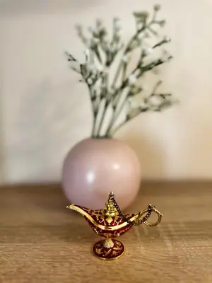 a small gold bird ornament with a vase of flowers at Cozy Corner Ljubljana in Ljubljana