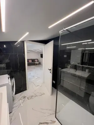 a bathroom with a black and white marble floor at APP Krofek in Zgornje Škofije