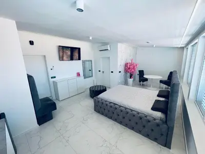 a bedroom with a bed and a table and chairs at ApartmaSLB in Slovenska Bistrica