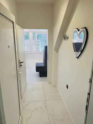 a hallway with a heart hanging on the wall at ApartmaSLB in Slovenska Bistrica