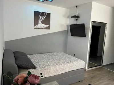 a small bedroom with a bed and a mirror at ApartmaSLB in Slovenska Bistrica